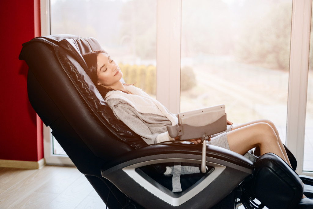 a young woman sitting on a massage chair