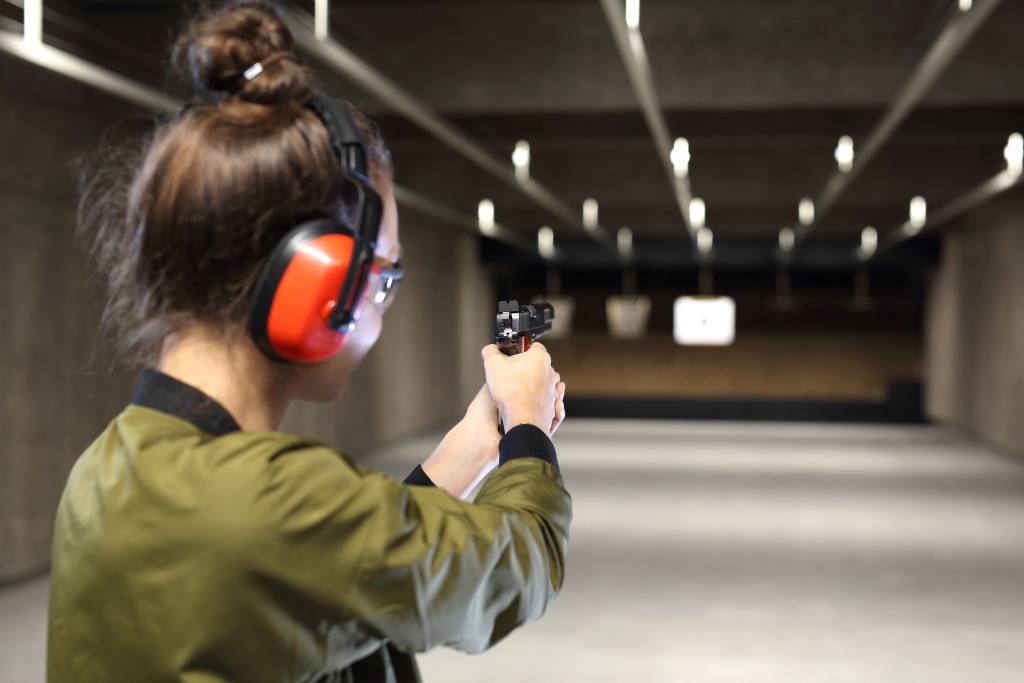 A gun store employee training how to handle gun