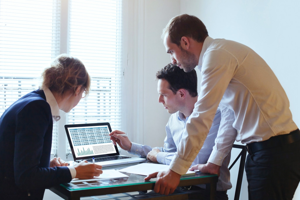 employees having discussion about charts and graphs