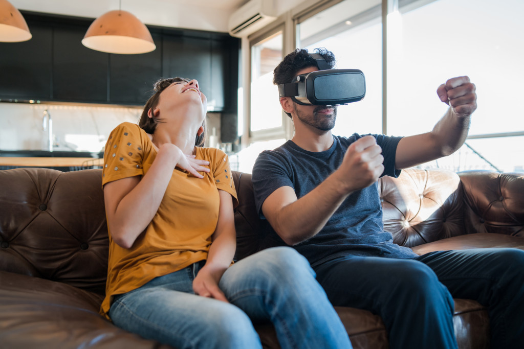 A couple in the living room playing VR games