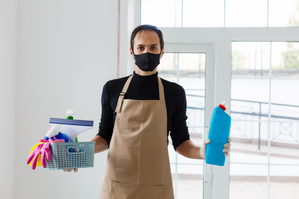 A man holding cleaning solutions for disinfection