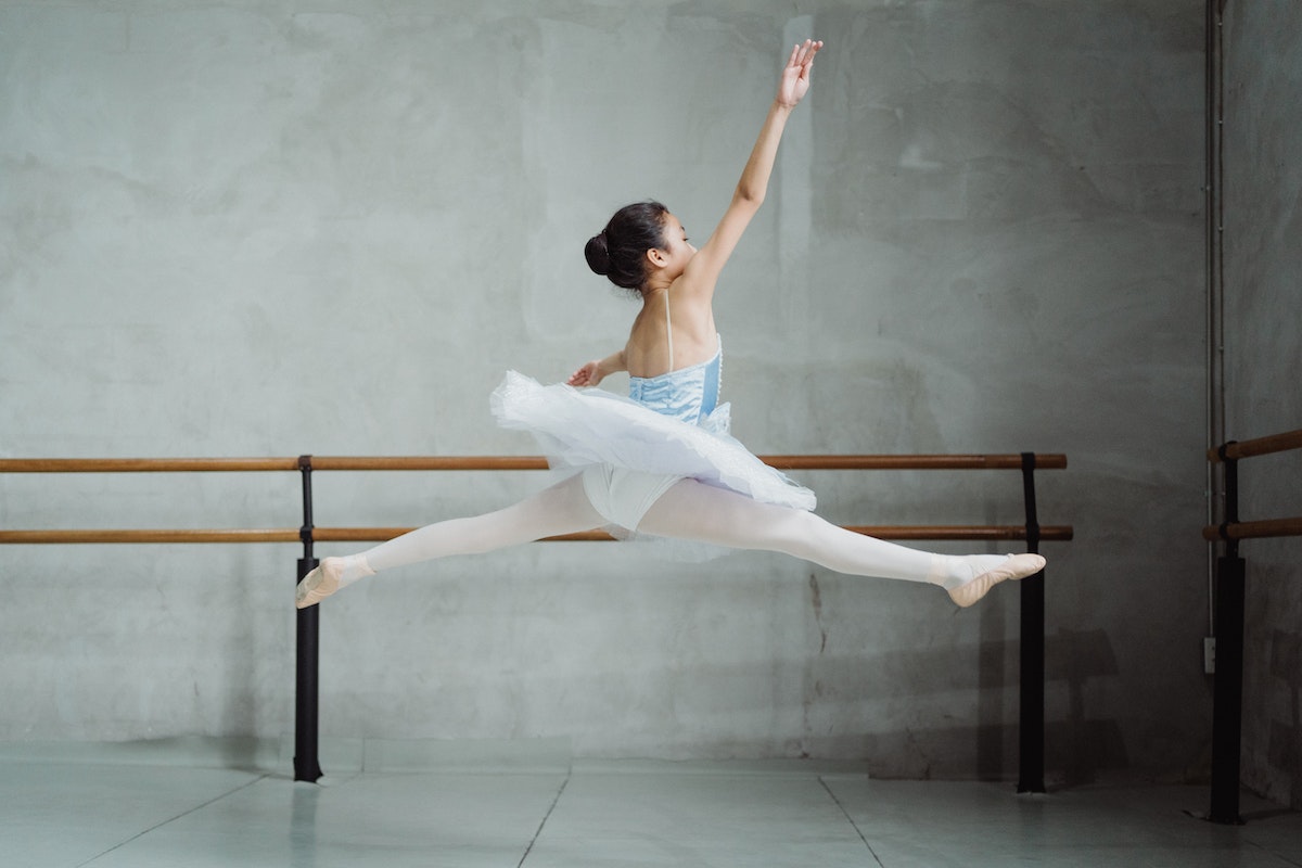 graceful ballerina doing twine jump