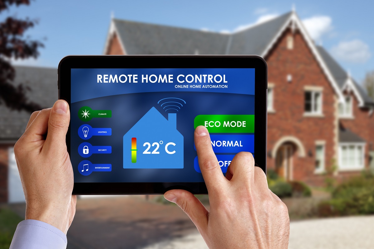man holding a smart energy controller for home