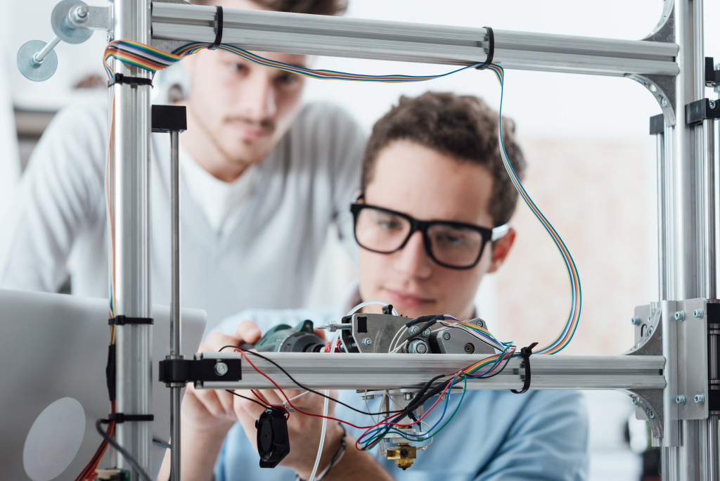 Engineers working on a 3D printer