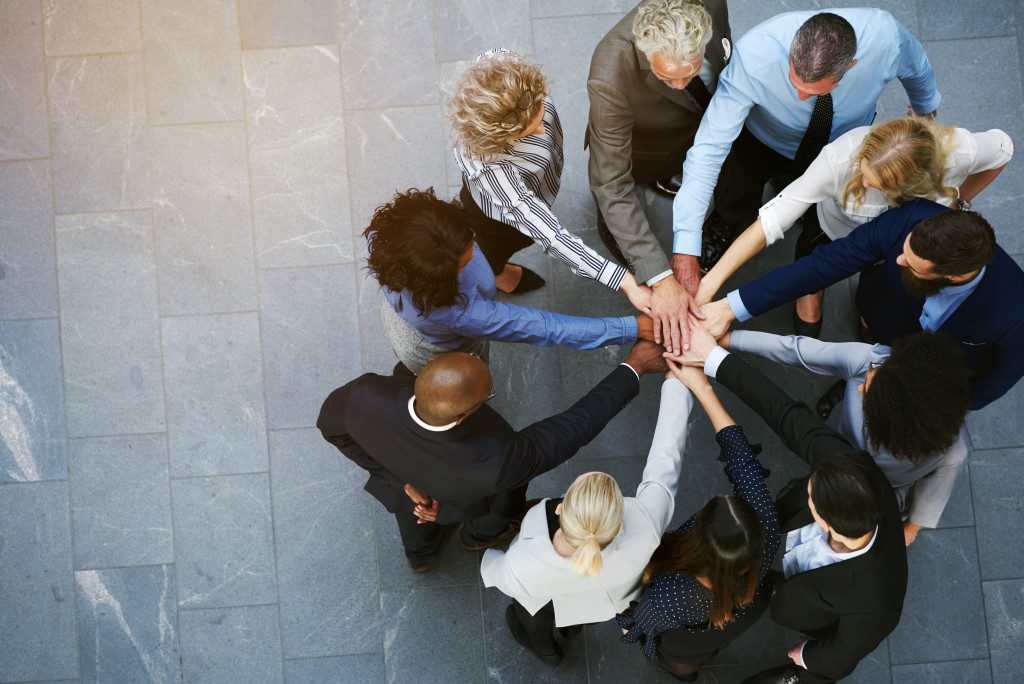 A team of diverse professionals huddled in an office