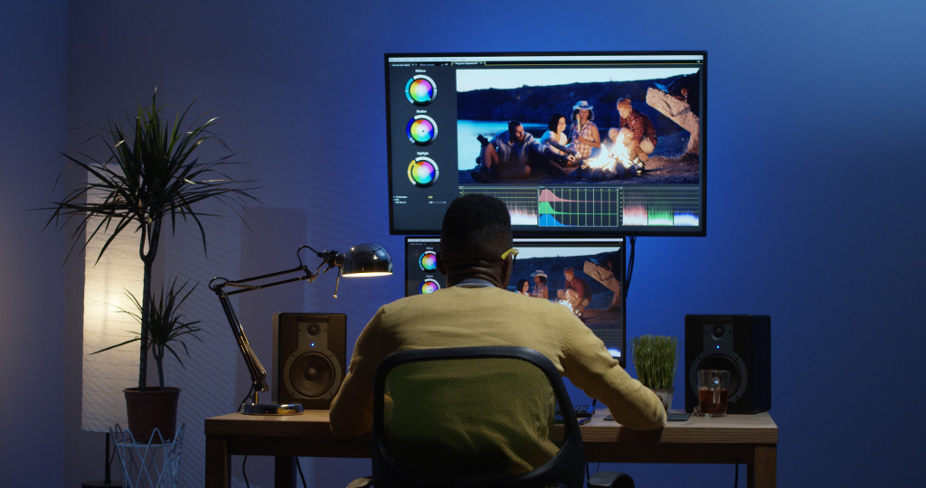 young man editing video in studio