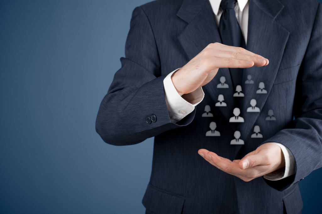 businessman holding a bunch of people icons representing target market