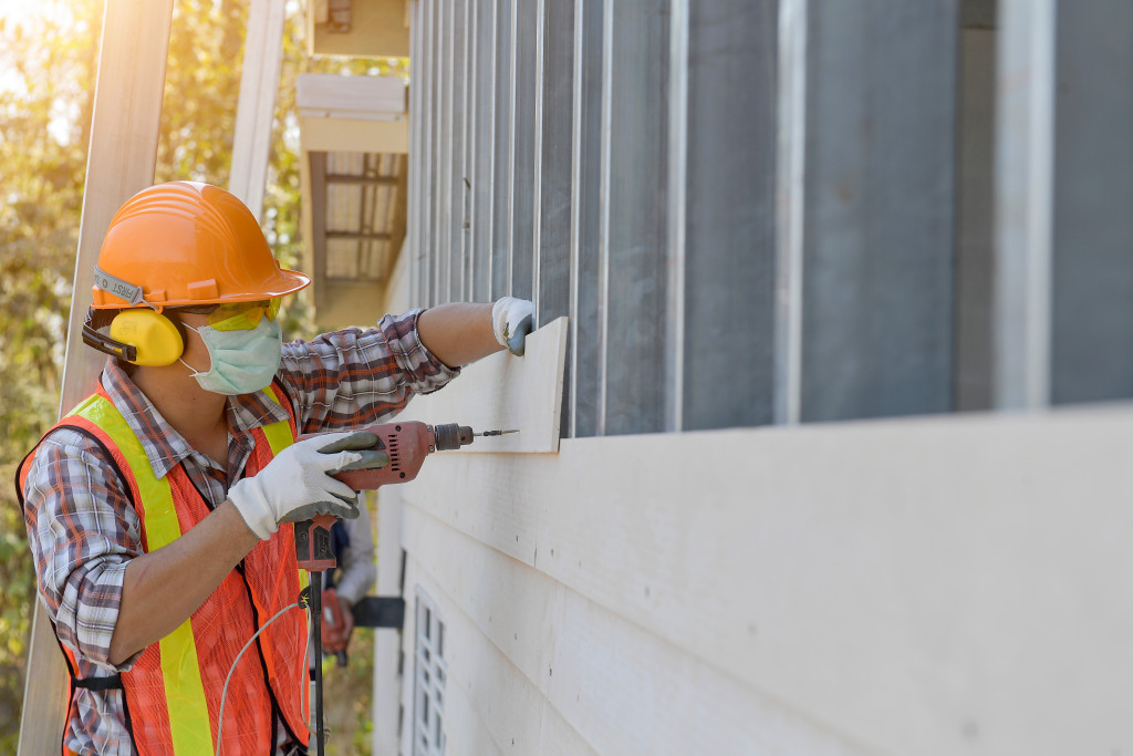 house construction worker adding wall wood