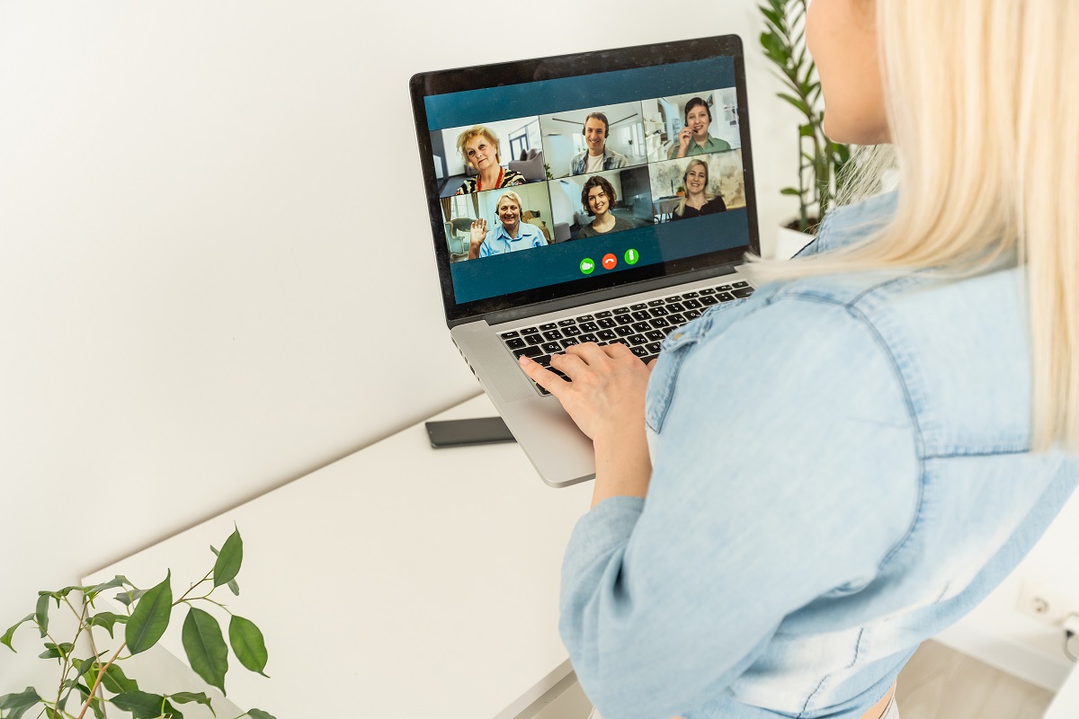 A businesswoman talking to colleagues on a video call